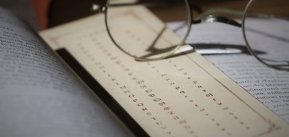 silver framed eyeglasses on white printer paper