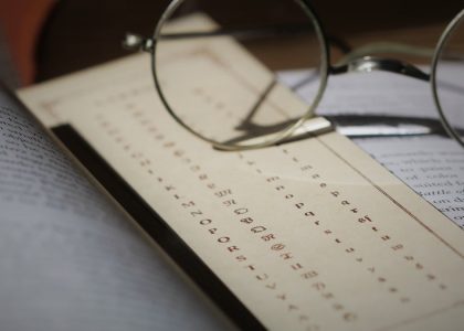 silver framed eyeglasses on white printer paper